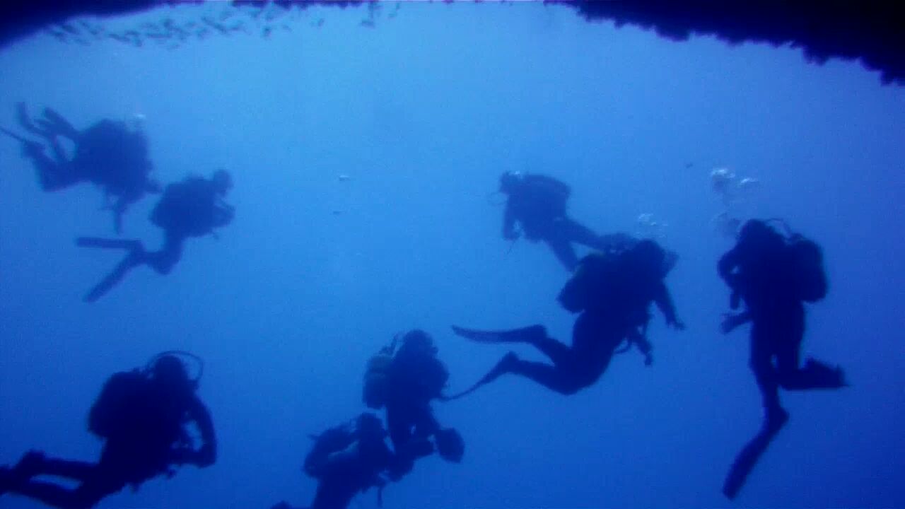 Diver at the entrance of Coral Cave, Gozo, Malta